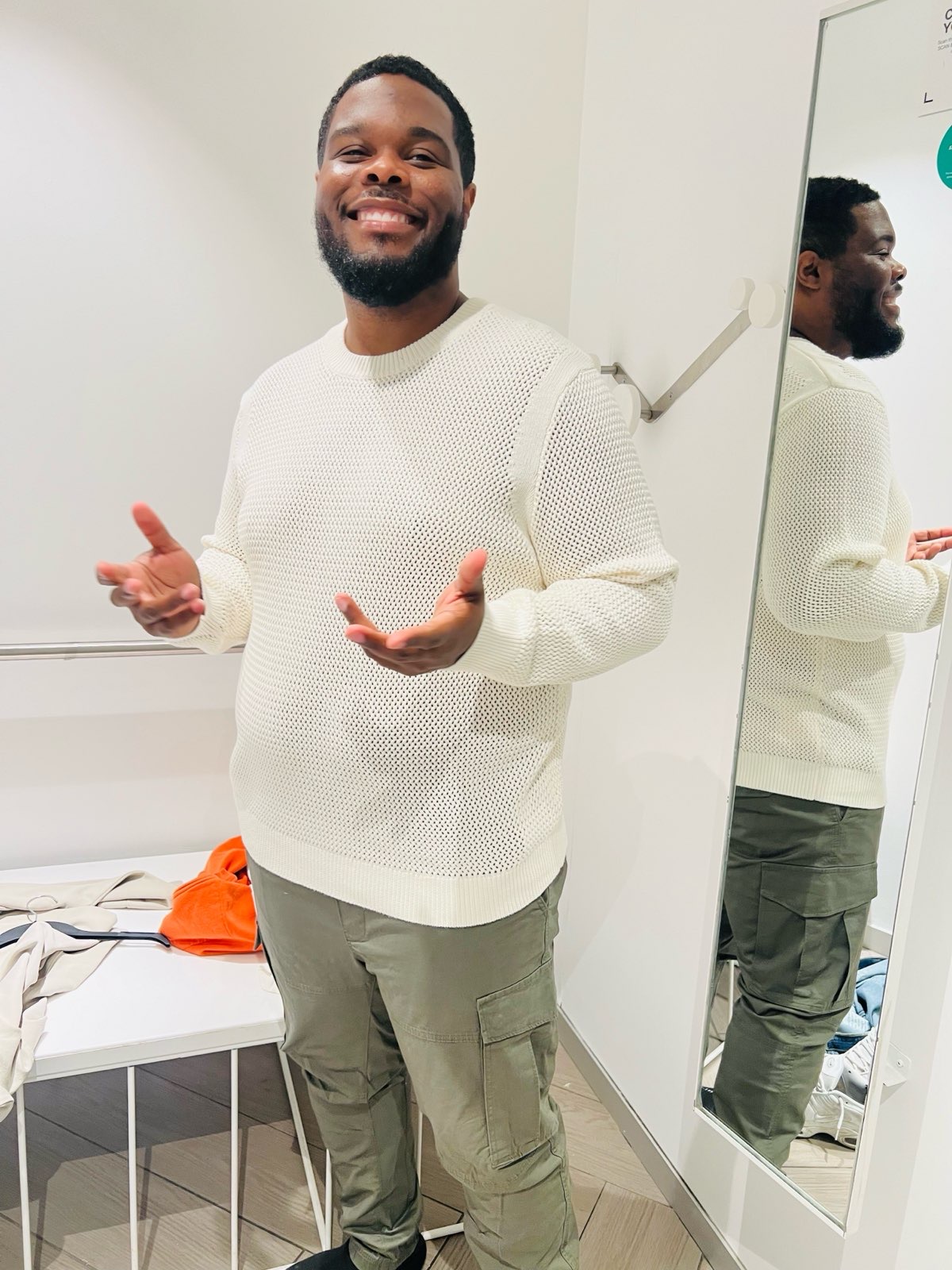 Ishmael smiling in white sweater